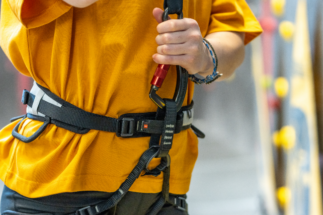 LOCK Climber check that auto belay carabiner is locked to harness